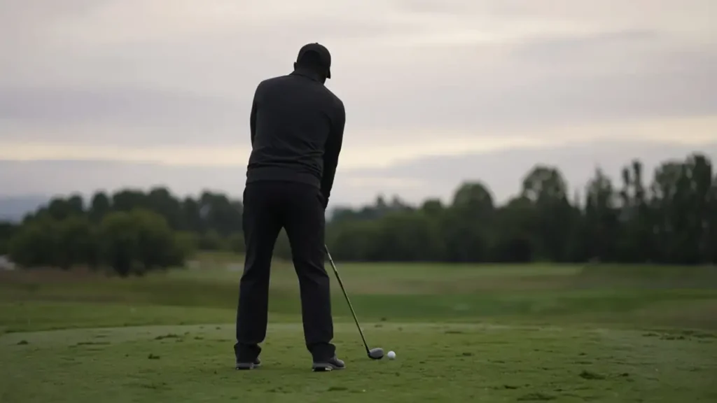 A golfer at address seen from behind